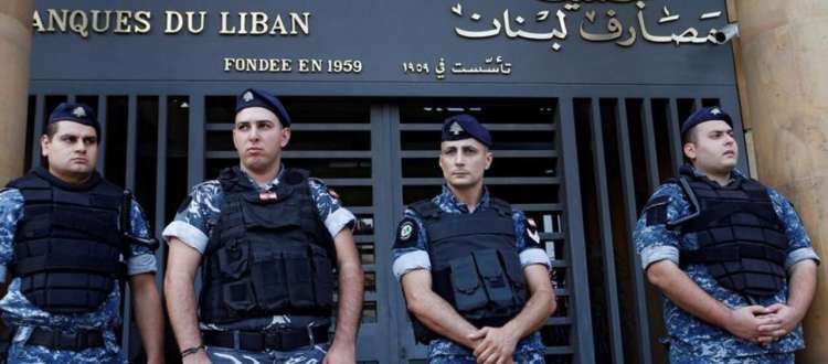 Lebanese police stand outside the entrance of the Association of Banks in downtown Beirut